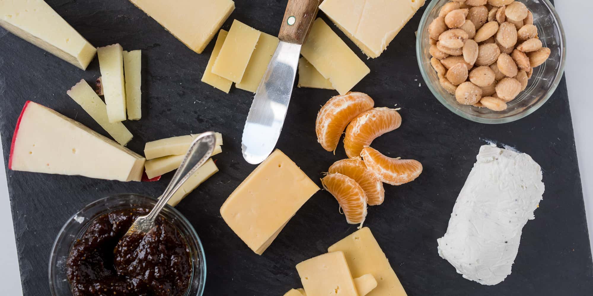 Cheese and accompaniments on slate board